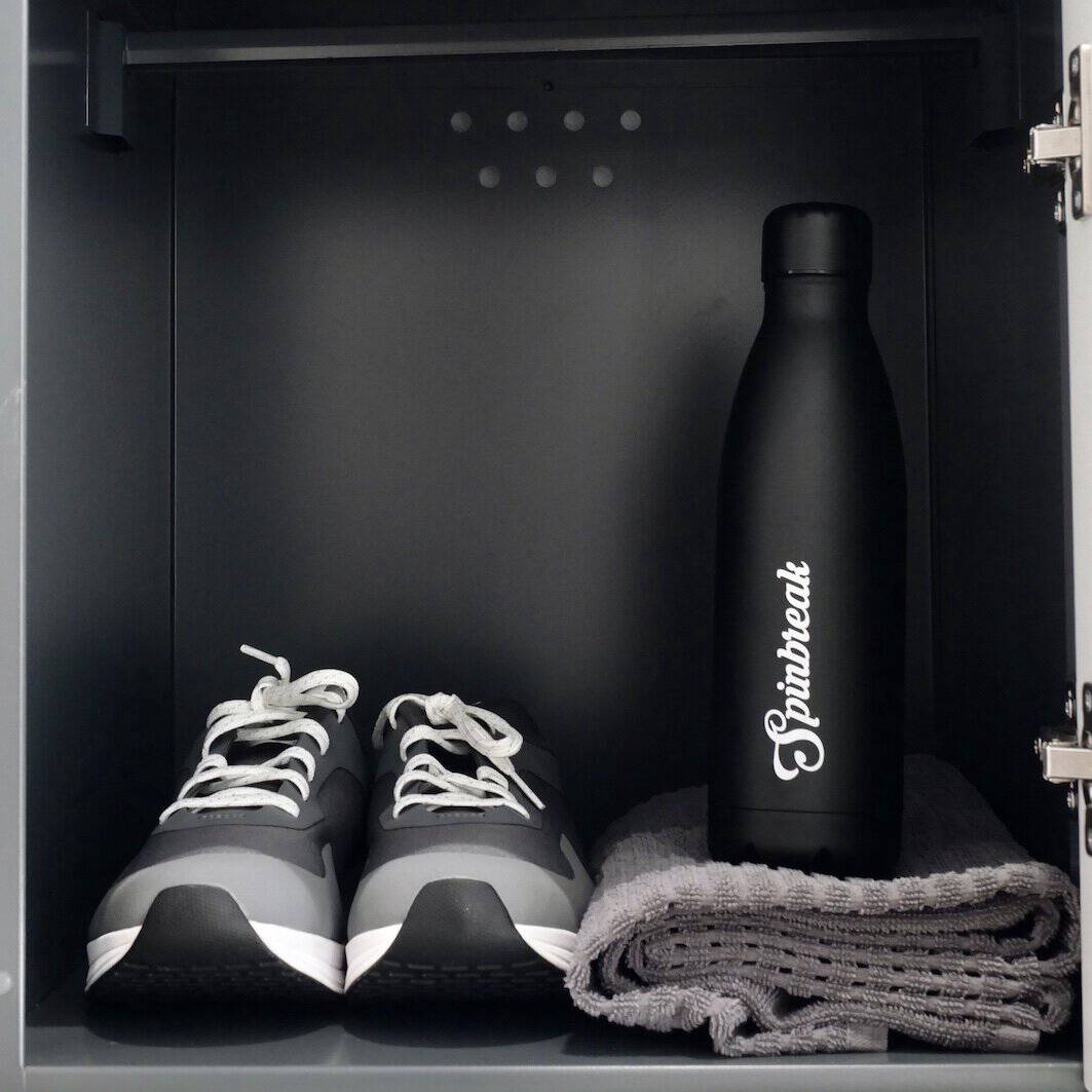 Indoor cycling shoes with a Spinbreak's Gourd and a Towel